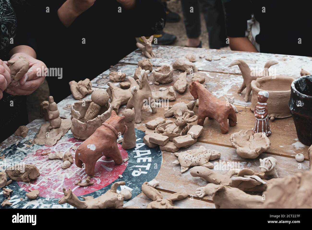 Moscow, Russia - September 5, 2020. Children sculpt clay figurines in the open air. Art, creativity. Modeling clay, cultural traditions, hobby Stock Photo