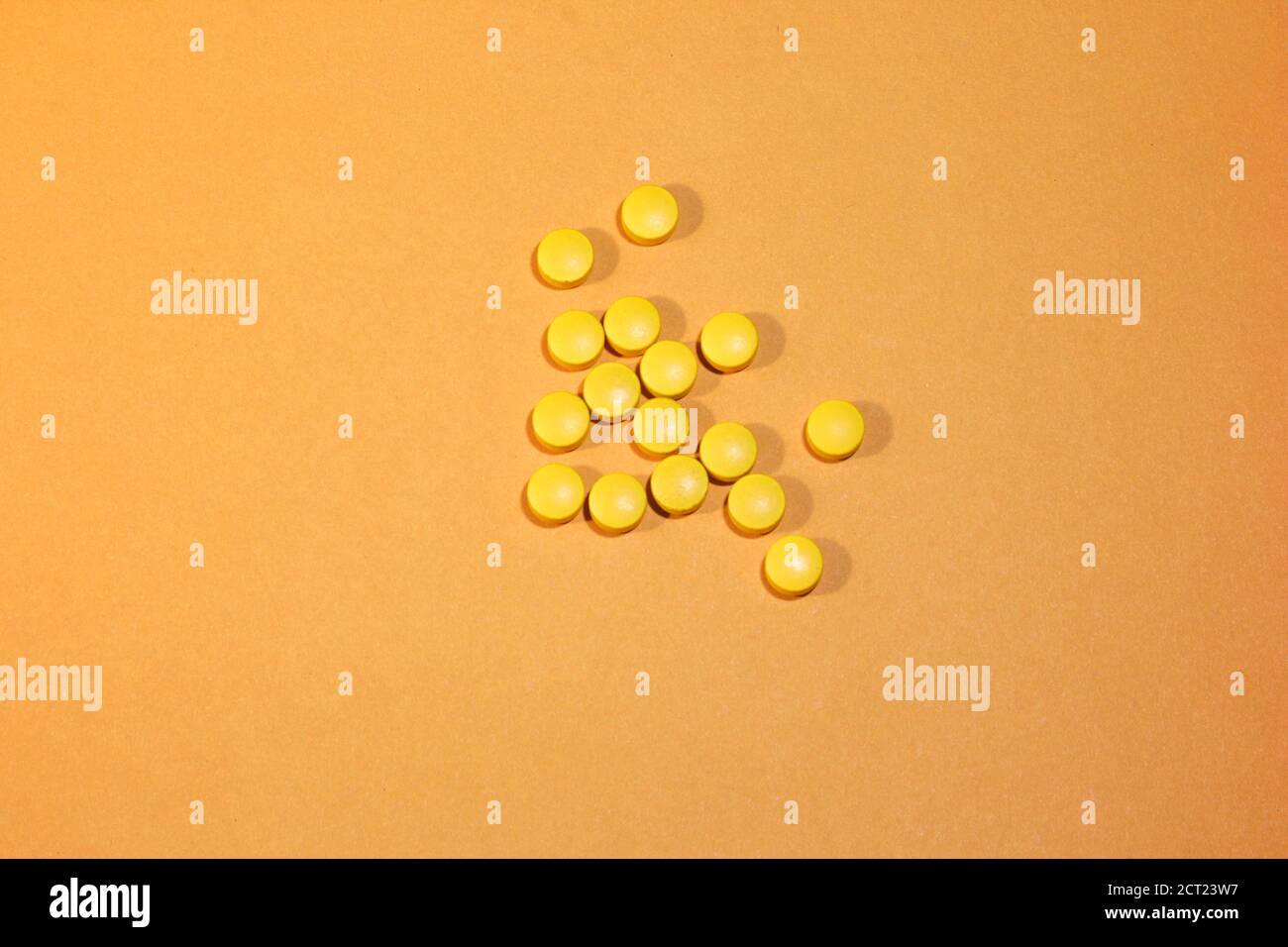 Yellow round tablets on a yellowackground. Abstract background. A