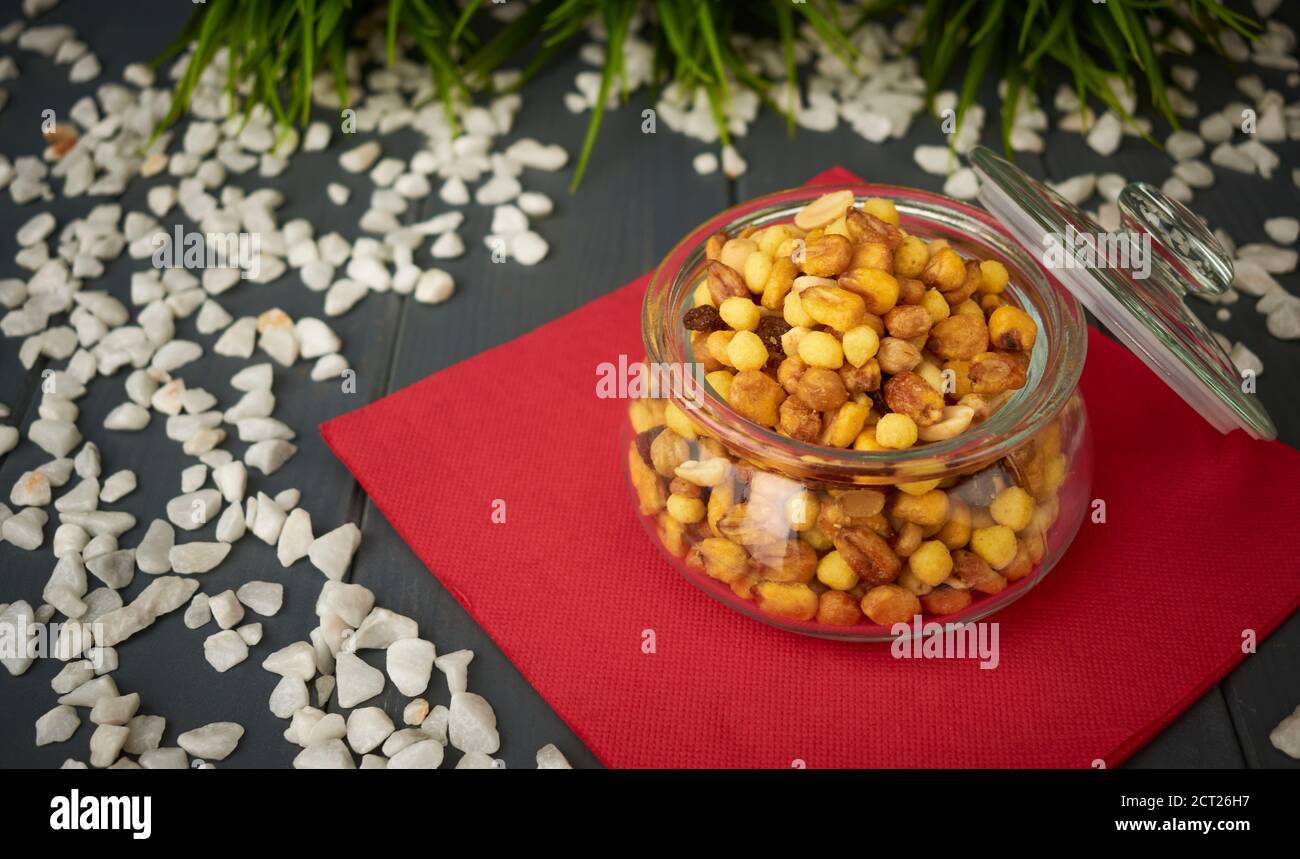 Glass jar of mixed nuts, ready to taste, on a catering table, to take with drinks Stock Photo