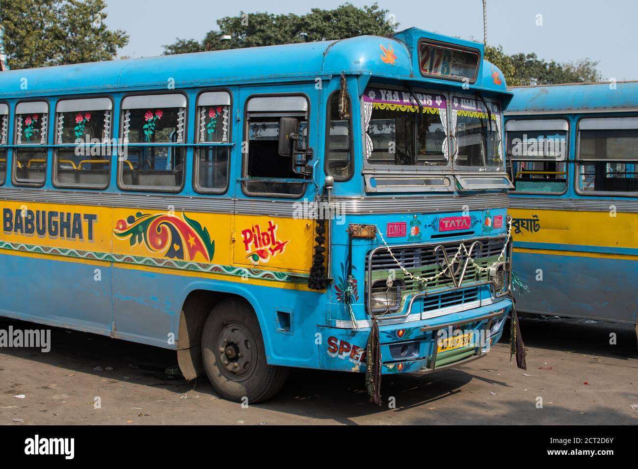 Kolkata, India - February 1, 2020: Two traditional turquoise and yellow public buses parked at a bus station on February 1, 2020 in Kolkata, India Stock Photo