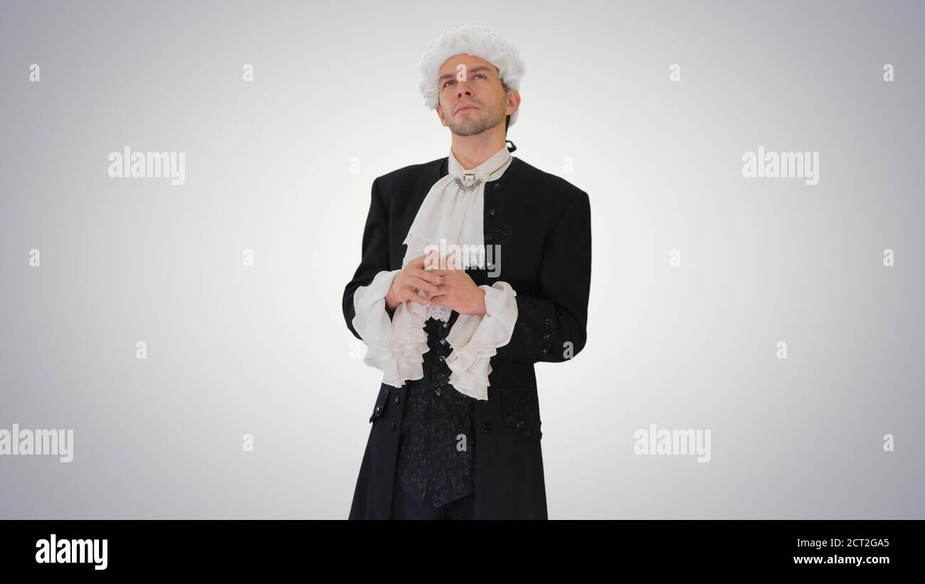 Man dressed in courtier frock coat and white wig thinking and fi Stock Photo