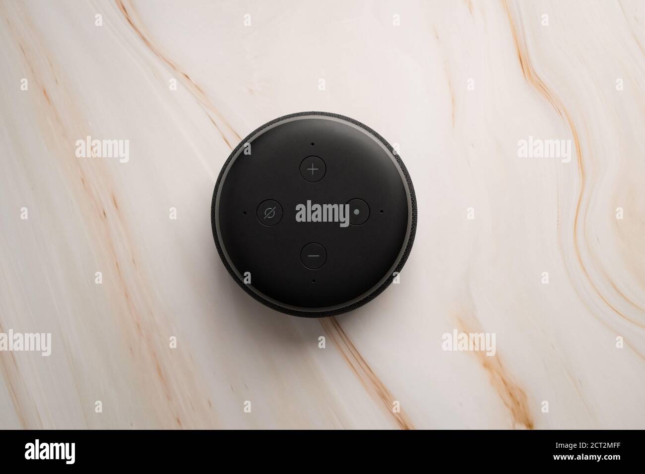 LONDON, UNITED KINGDOM - SEPTEMBER 20 2020: Close-up of an Amazon Echo Dot, the virtual assistant speaker, with a modern marble background. Stock Photo