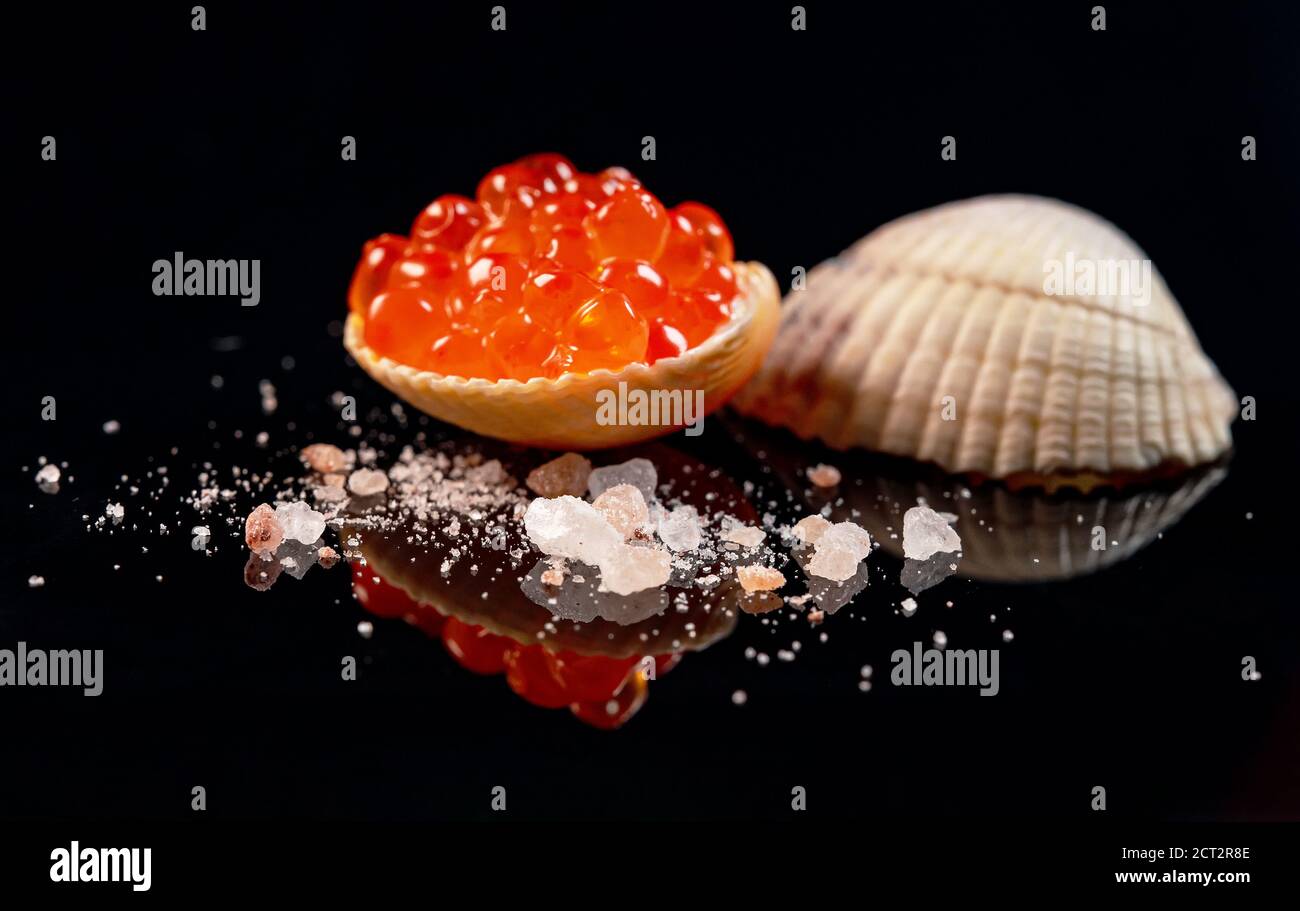 Caviar Shells Red caviar in seashell on mirror surface Stock Photo - Alamy