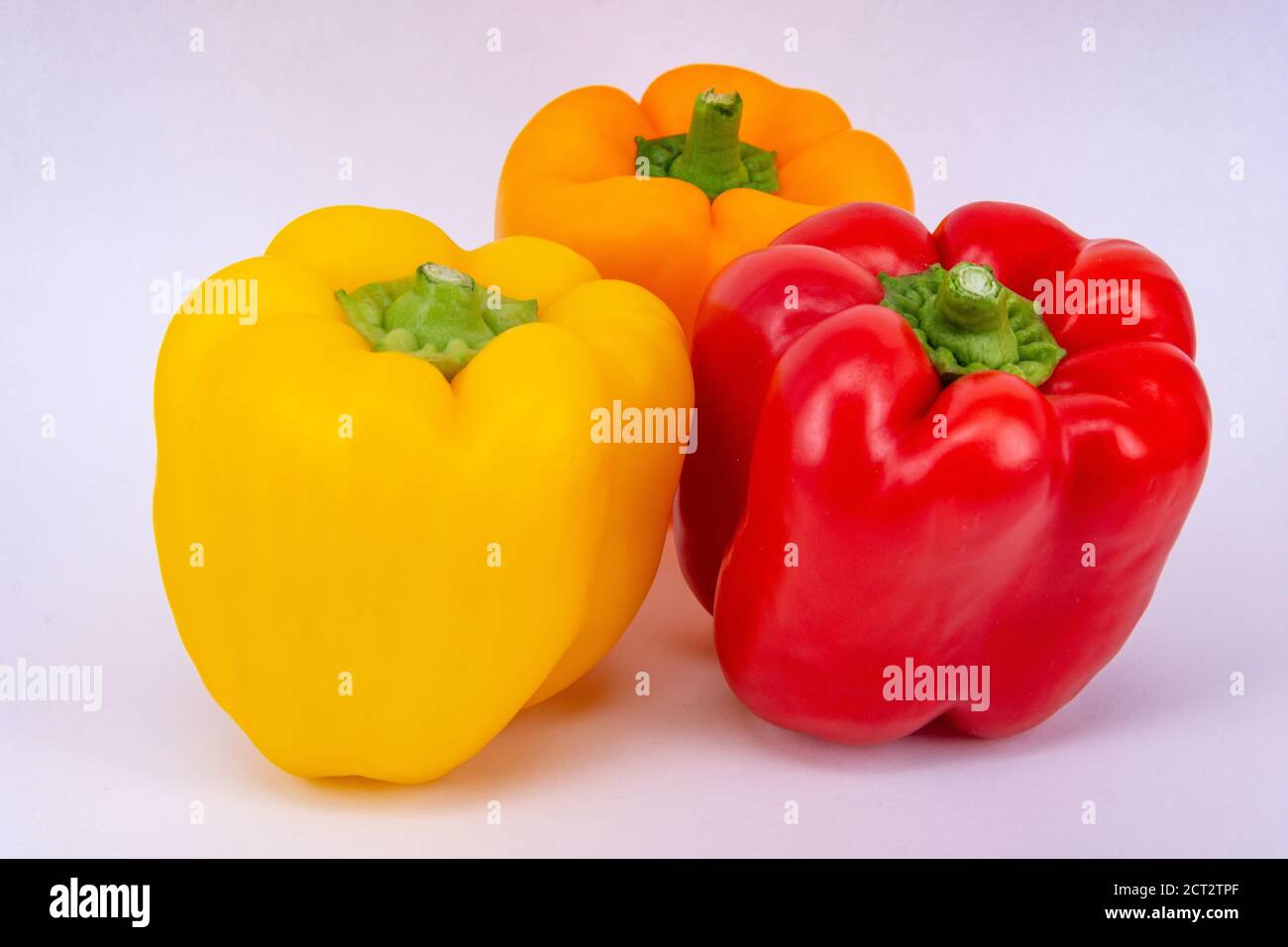Still-life of red orange and yellow Bell Peppers (Capsicum annuum), Surrey, England, United Kingdom Stock Photo