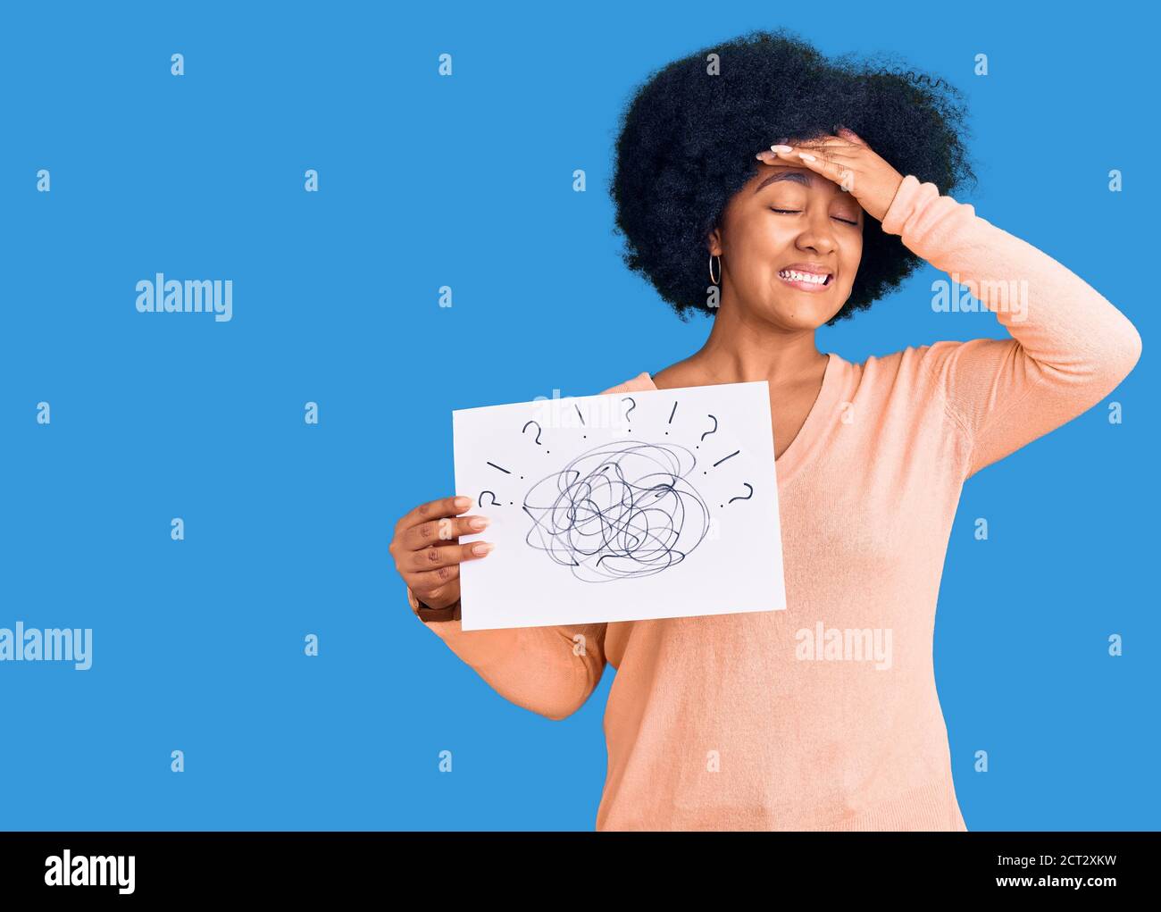 Young african american girl holding scribble draw stressed and ...