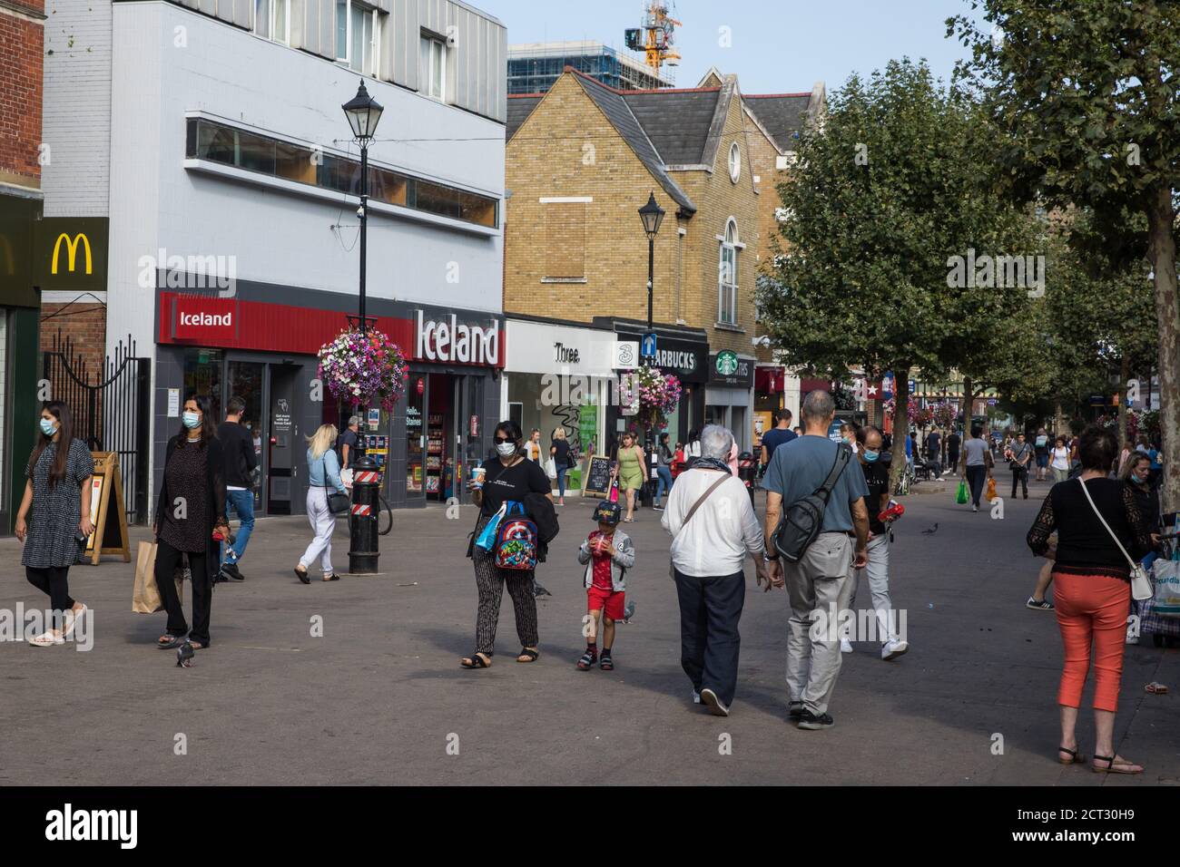 Staines-upon-Thames, UK. 20th September, 2020.Local residents, some of whom wearing face coverings, do some Sunday shopping in the town centre. The Borough of Spelthorne, of which Staines-upon-Thames forms part along with Ashford, Sunbury-upon-Thames, Stanwell, Shepperton and Laleham, has been declared an Ôarea of concernÕ for COVID-19 by the government following a marked rise in coronavirus infections which is inconsistent with other areas of Surrey. Credit: Mark Kerrison/Alamy Live News Stock Photo