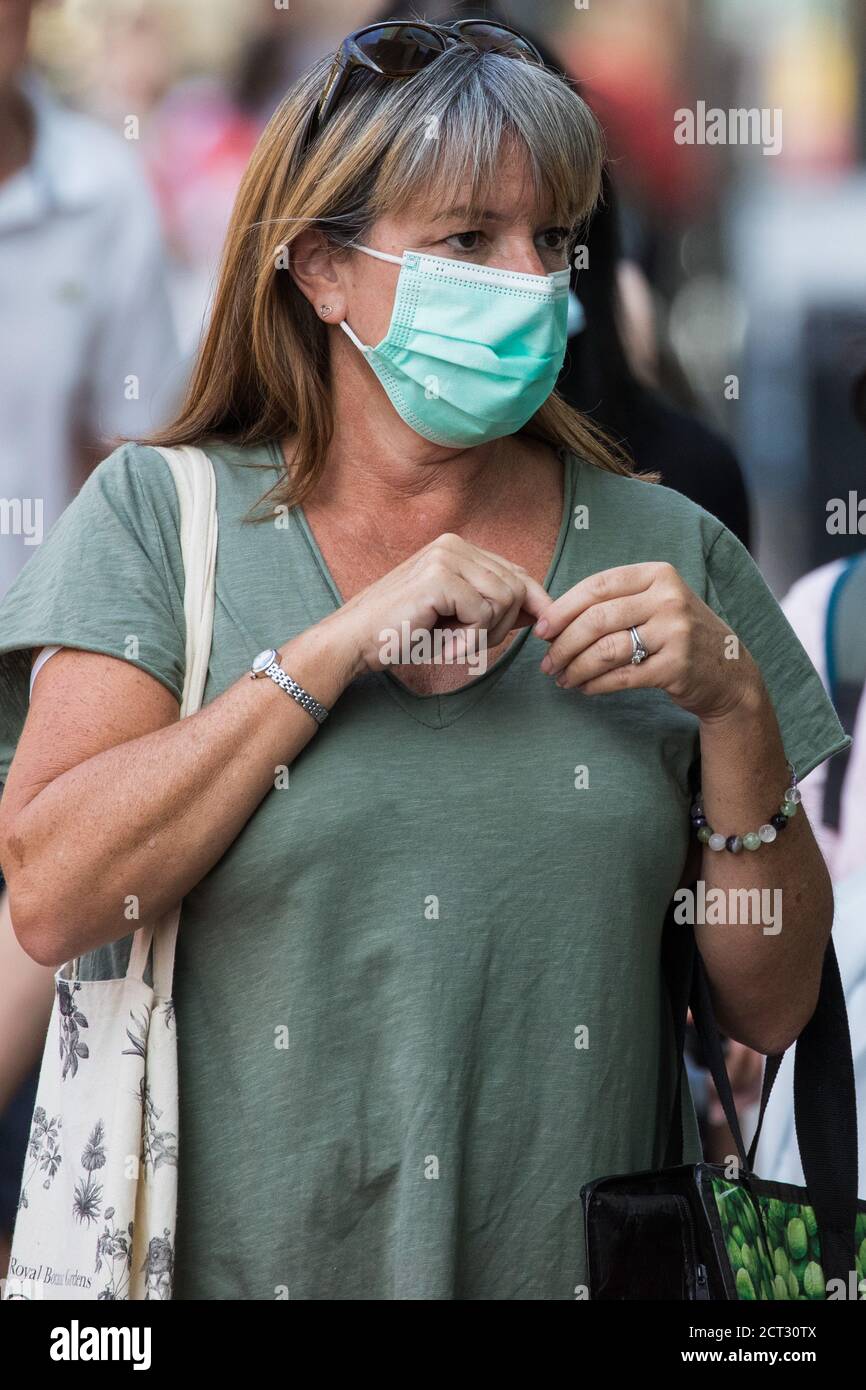 Staines-upon-Thames, UK. 20th September, 2020. A shopper wears a face covering to help prevent the spread of the coronavirus. The Borough of Spelthorne, of which Staines-upon-Thames forms part along with Ashford, Sunbury-upon-Thames, Stanwell, Shepperton and Laleham, has been declared an Ôarea of concernÕ for COVID-19 by the government following a marked rise in coronavirus infections which is inconsistent with other areas of Surrey. Credit: Mark Kerrison/Alamy Live News Stock Photo