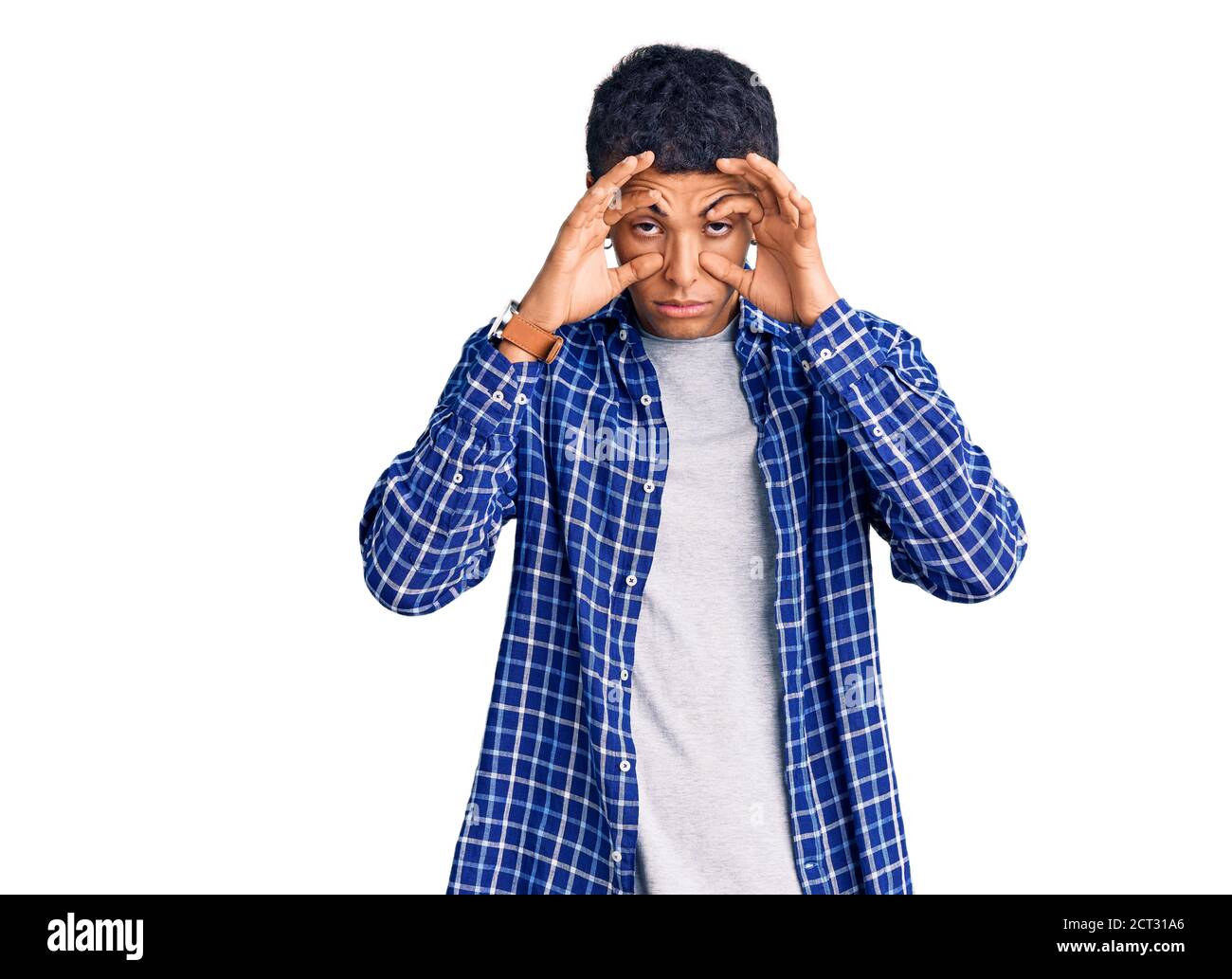 Young african amercian man wearing casual clothes trying to open eyes with fingers, sleepy and tired for morning fatigue Stock Photo