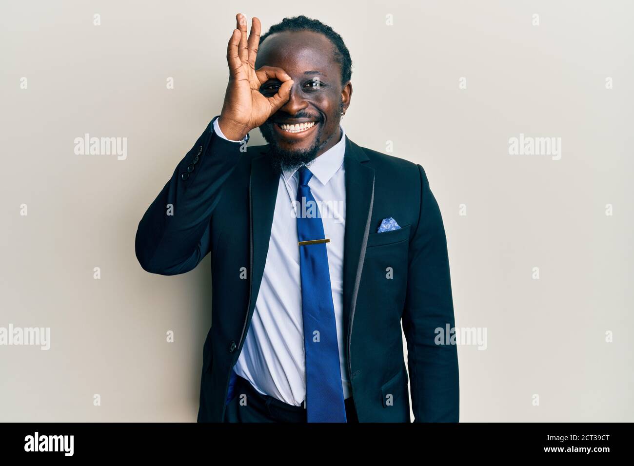 Handsome young black man wearing business suit and tie smiling happy ...
