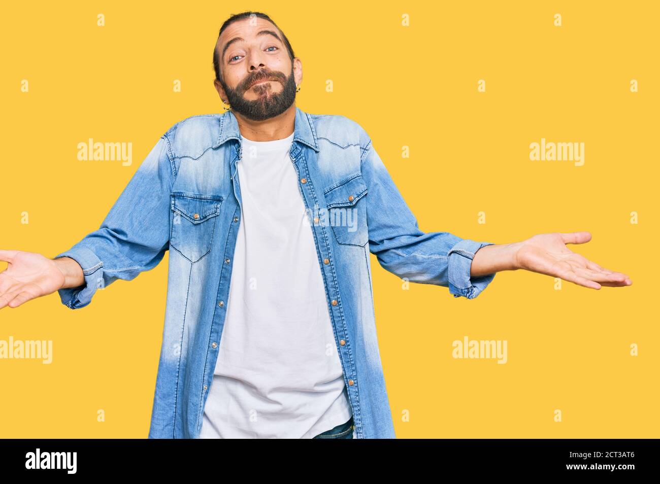 Attractive Man With Long Hair And Beard Wearing Casual Denim Jacket