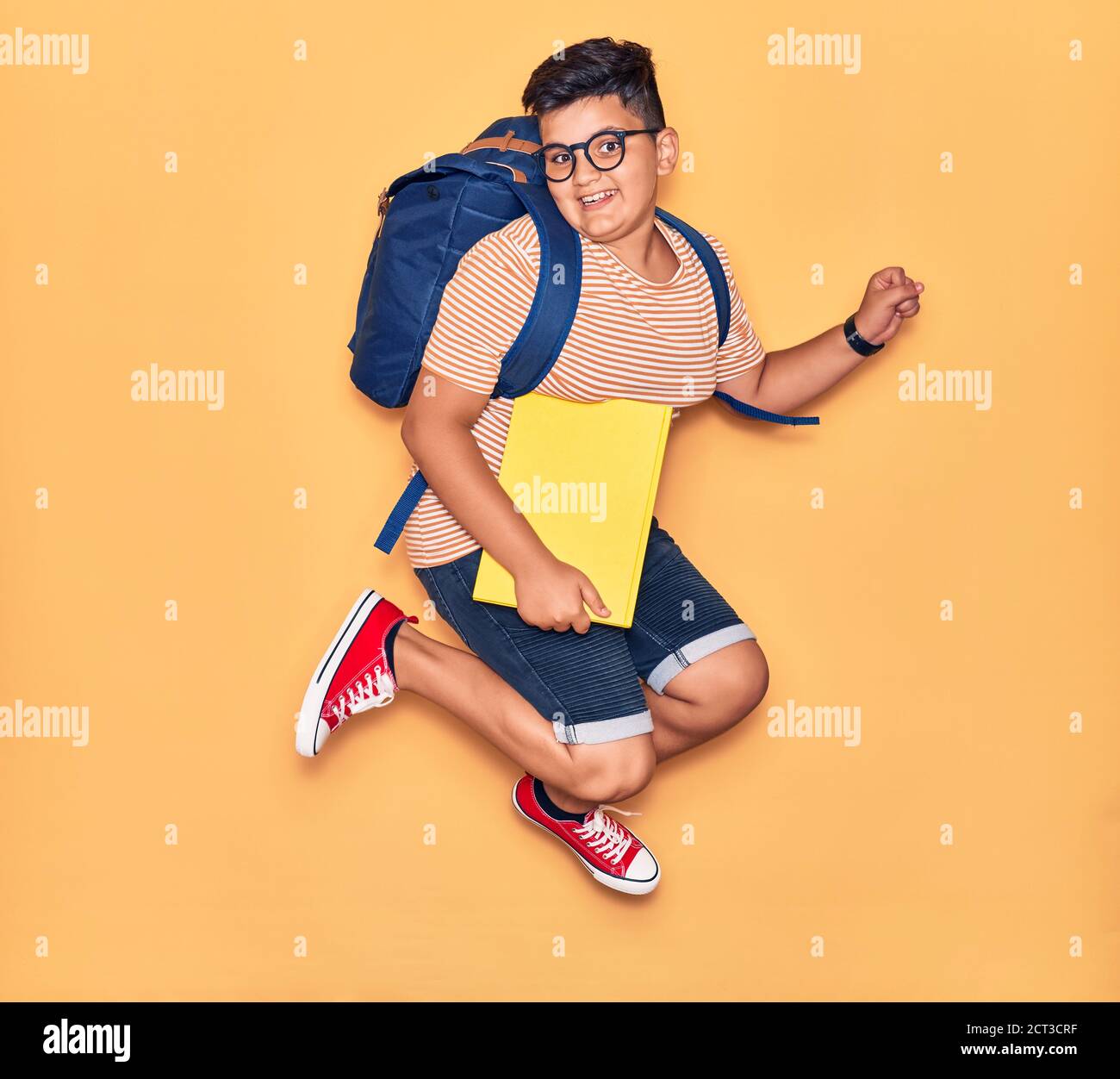 Adorable student boy wearing glasses and backpack smiling happy ...