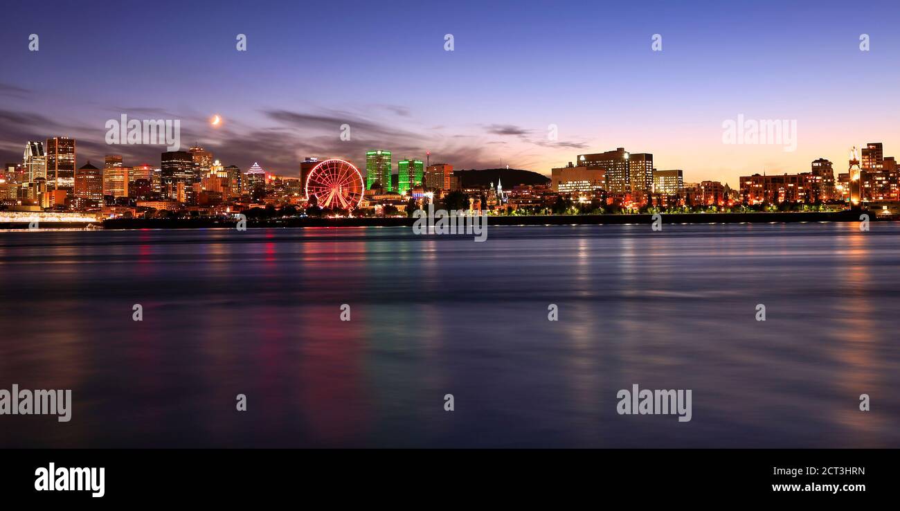 Montreal skyline at dusk reflected in St Lawrence River Stock Photo