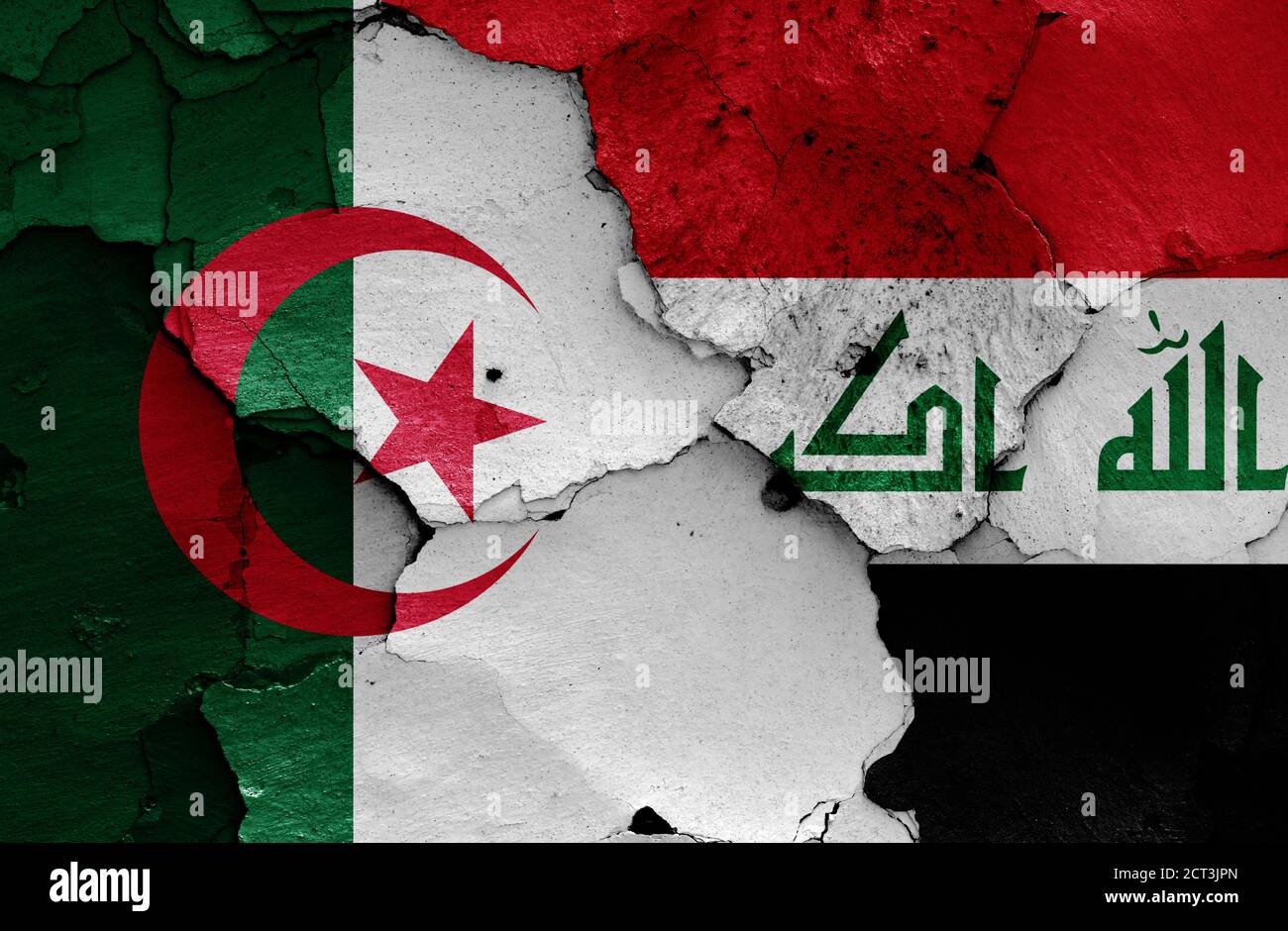 flags of Algeria and Iraq painted on cracked wall Stock Photo