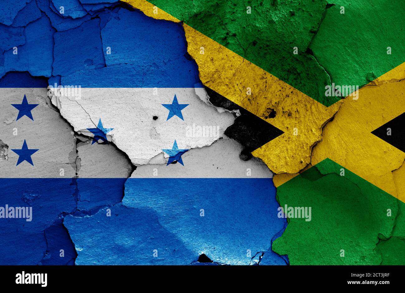 flags of Honduras and Jamaica painted on cracked wall Stock Photo