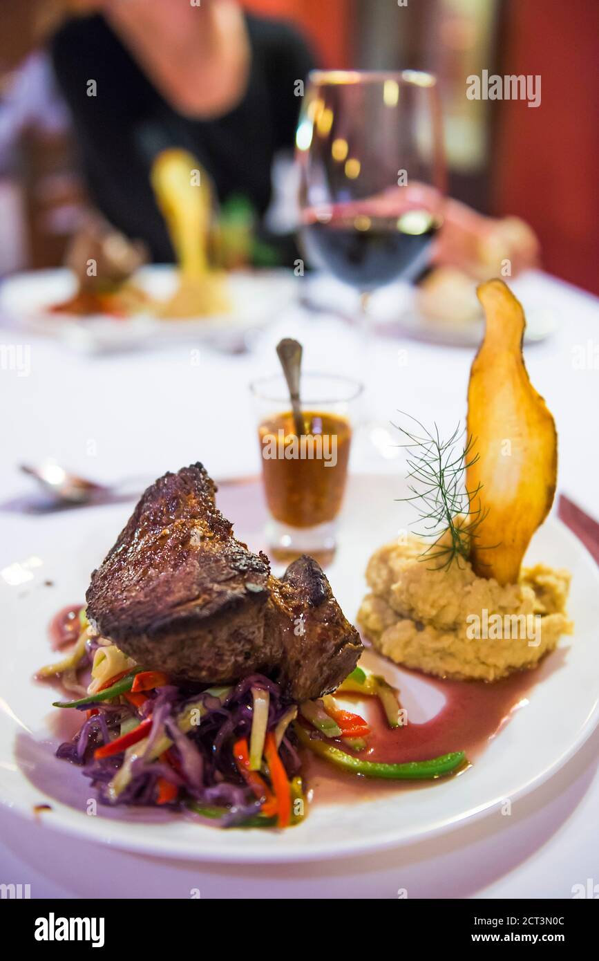 Delicious Argentinian Steak Dinner at a fine dining restaurant with a glass of red wine, North Argentina, South America Stock Photo
