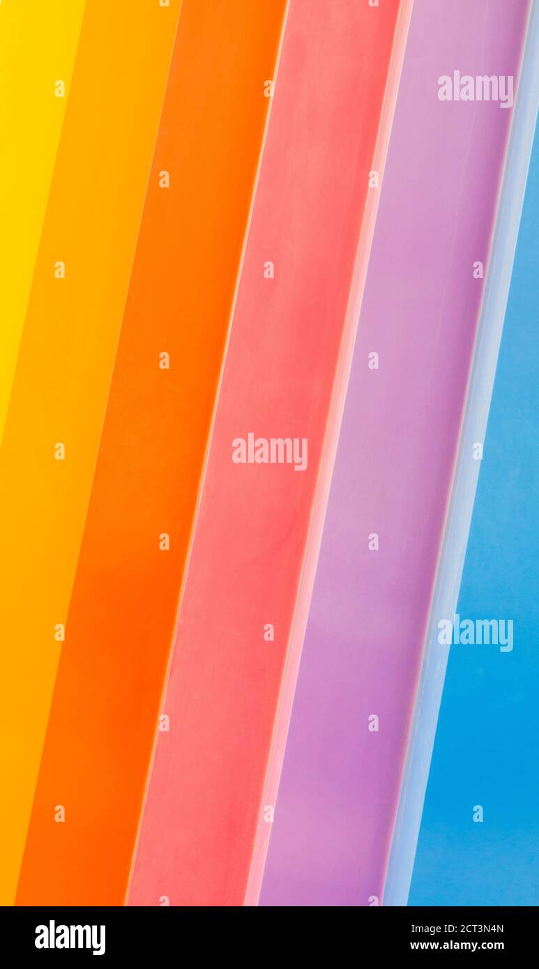 background texture-vibrant rainbow stripes painted diagonally on weathered wood Stock Photo