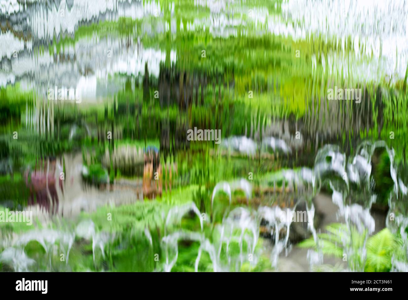 An abstract blurred motion waterfall background seeing the inside of a tropical greenhouse in montreal canada. Stock Photo