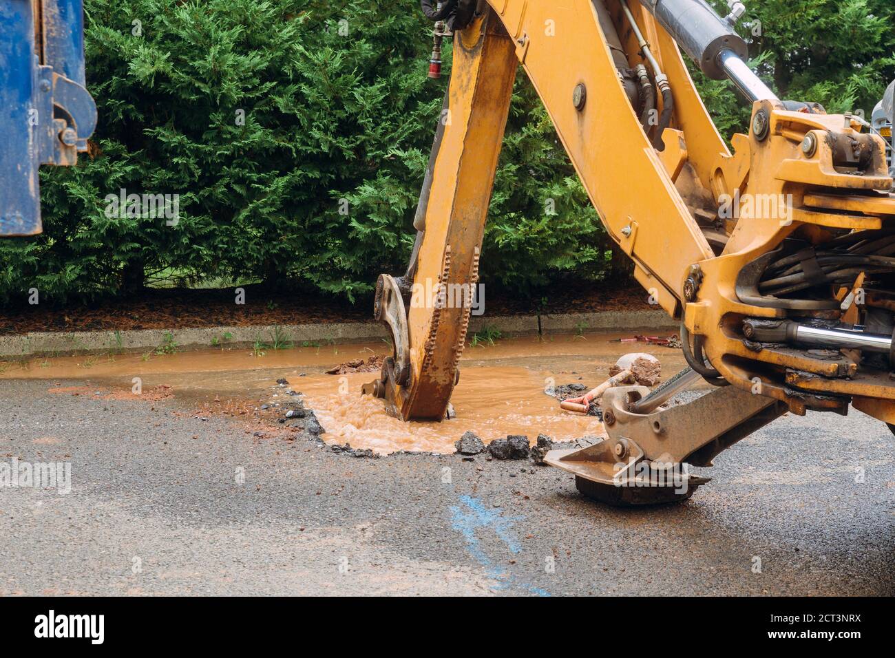 Splatter of water from broken pipe the main road water leaking from hole Stock Photo