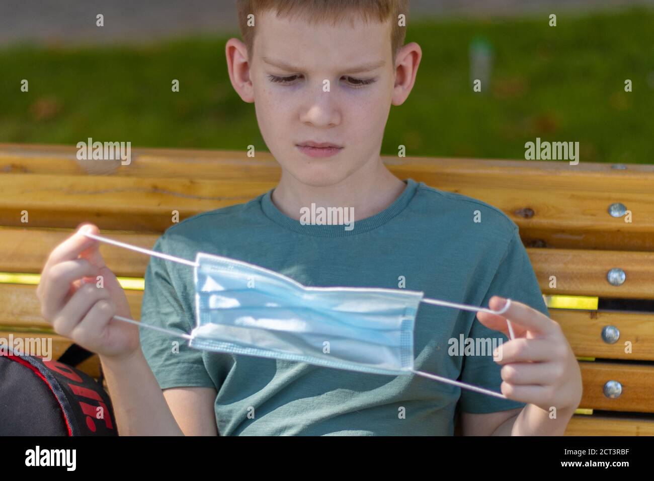 Young caucasian boy looking at the medicine mask then wearing it Stock ...