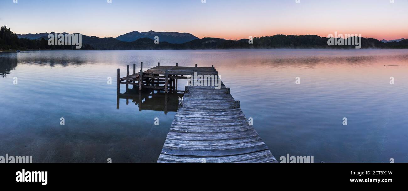 Pier on Lake Nahuel Huapi during a misty sunrise, Villa la Angostura, Neuquen, Patagonia, Argentina, South America, background with copy space Stock Photo