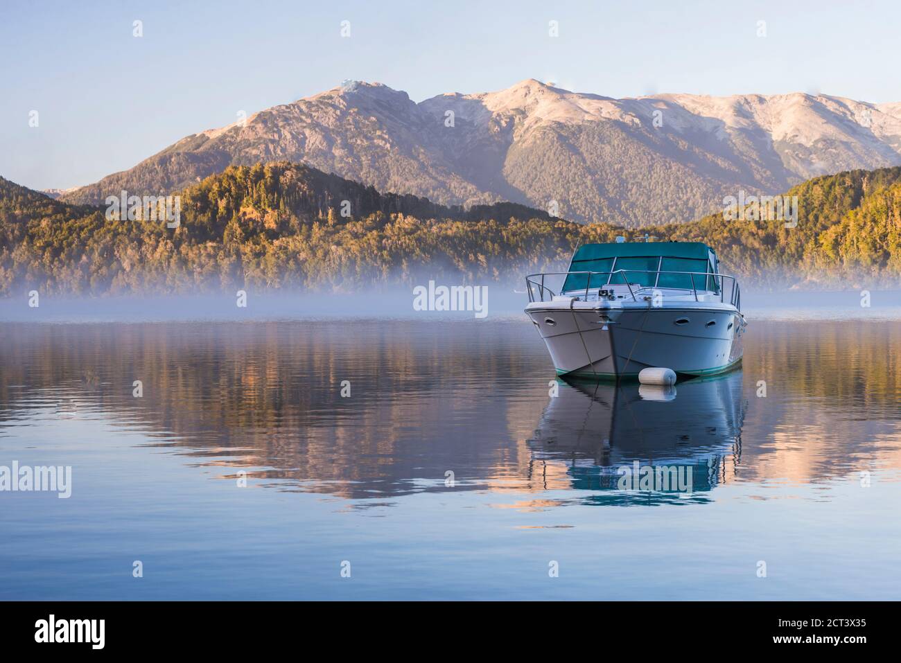 Sped boat on a misty Lake Nahuel Huapi at sunrise, Villa la Angostura, Neuquen, Patagonia, Argentina, South America Stock Photo
