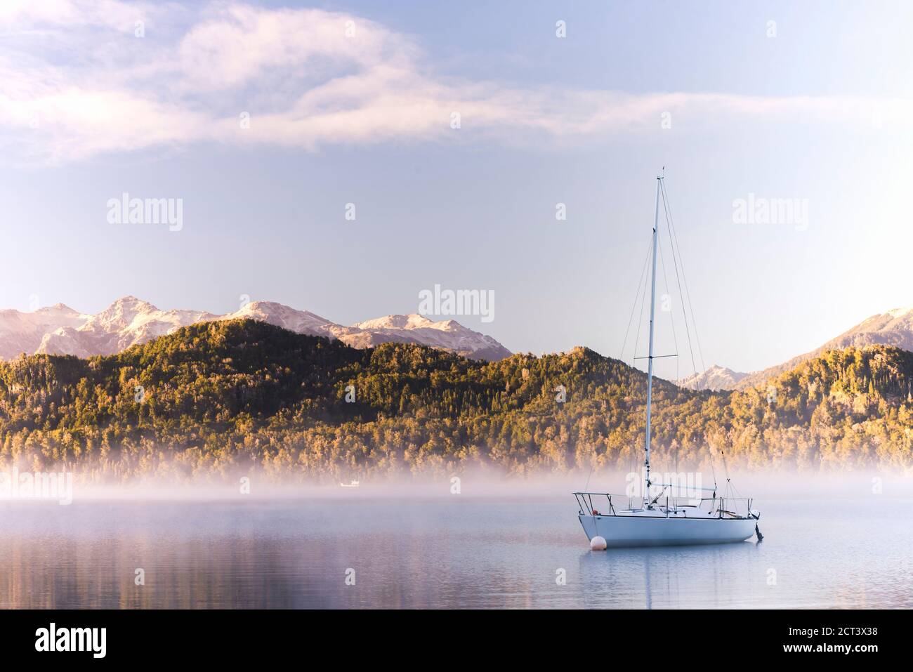Sailing boat on misty Lake Nahuel Huapi at sunrise, Villa la Angostura, Neuquen, Patagonia, Argentina, South America, background with copy space Stock Photo