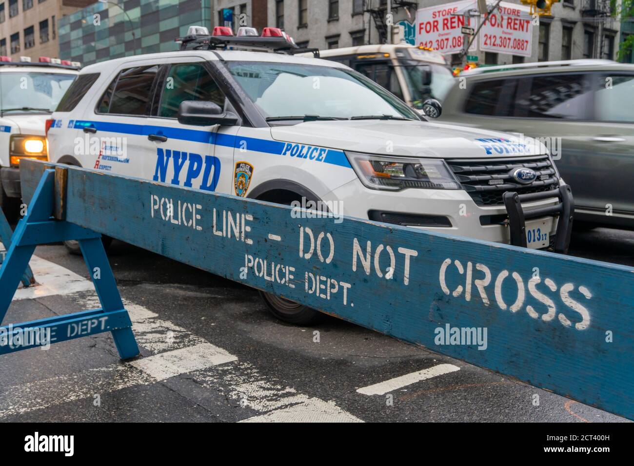 NYPD police vehicle and do not cross traffic barricade Stock Photo