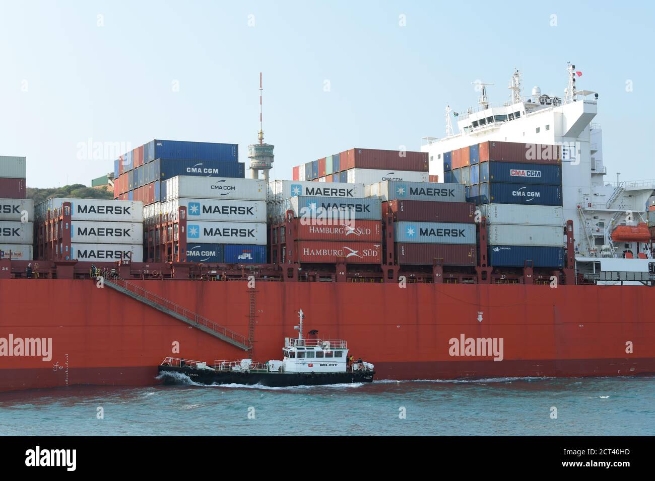 Harbour pilot boat Lufafa sailing next to container ship San Felix