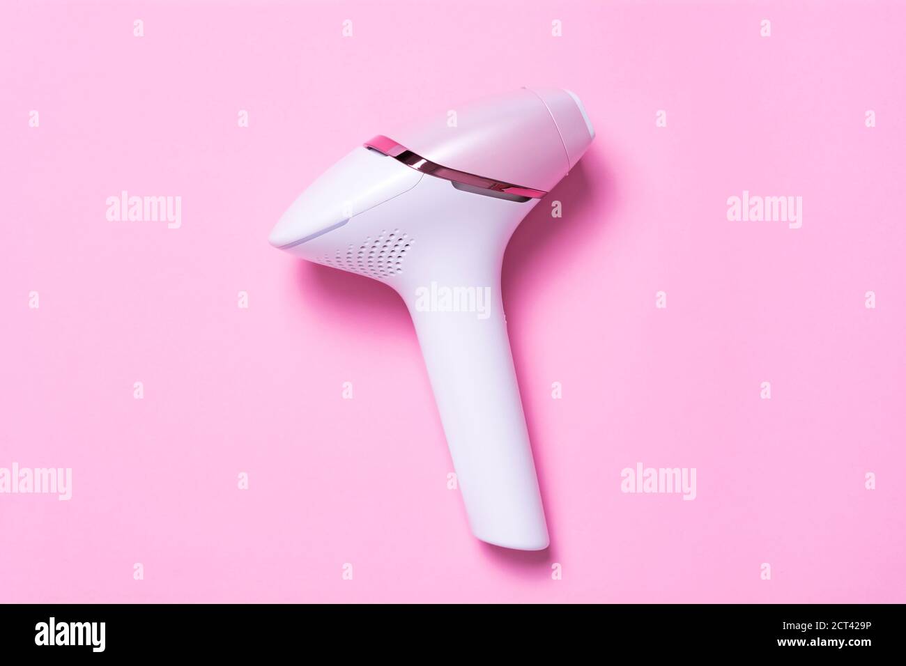 Photoepilator on a pink background. Hair removal tool Stock Photo