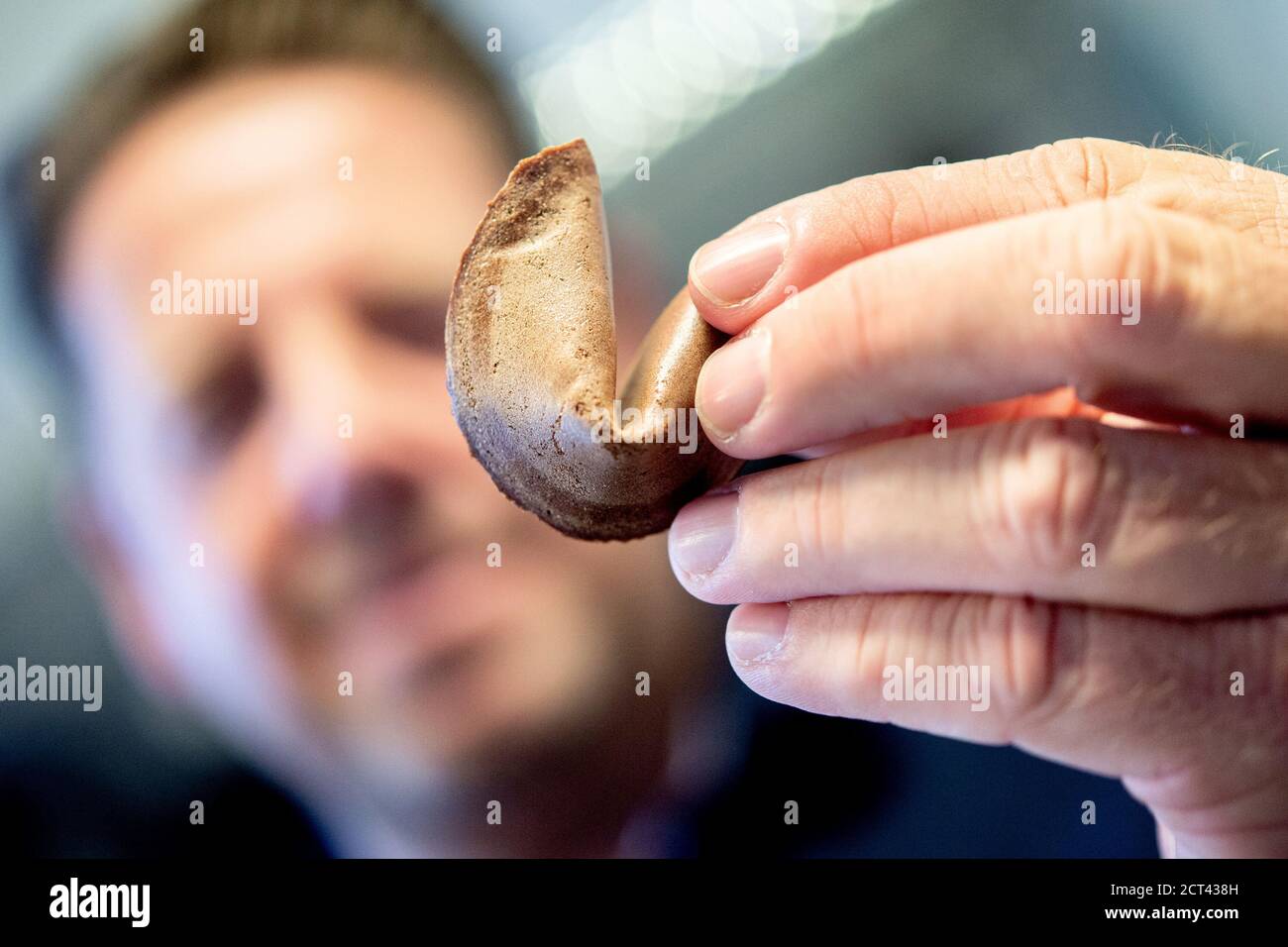 Hameln, Germany. 10th Sep, 2020. Michael Rohrdrommel, founder and managing director of Happy Glückskeks, holds a fortune cookie in his hands in the company's warehouse. Since 2018 the start-up from Hameln has been developing and producing its own fortune cookies with inspiring messages. (to dpa 'Lower Saxony wants to sell one million fortune cookies a year' from 21.09.2020) Credit: Hauke-Christian Dittrich/dpa/Alamy Live News Stock Photo