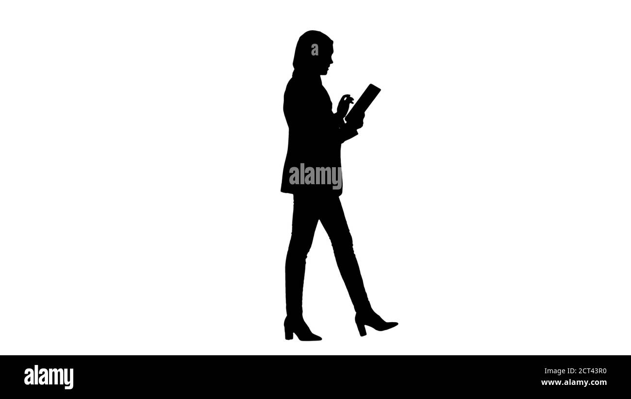 Silhouette Arabian businesswoman in hijab using tablet computer Stock Photo