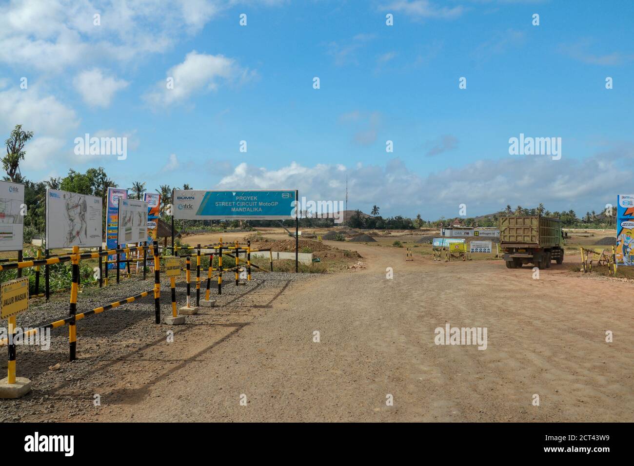 Construction of a complex on the MotoGP Mandalika circuit, West Nusa Tenggara, Lombok, Indonesia. Banners with a plan of the area and the racing Stock Photo