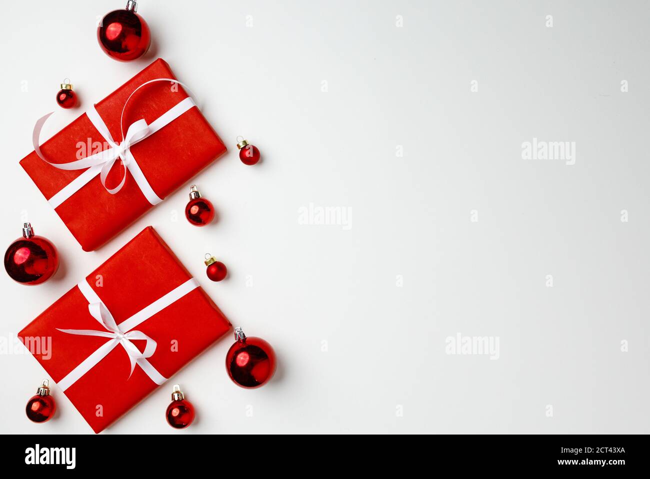 Red gift boxes and Christmas baubles on white background Stock Photo ...