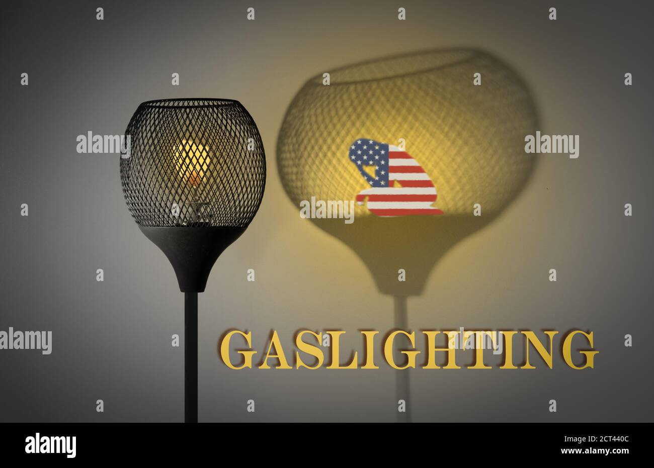 Gaslight with silhouette of woman draped in American flag in shadow cast by the lamp, Gaslighting text, concept illustration Stock Photo