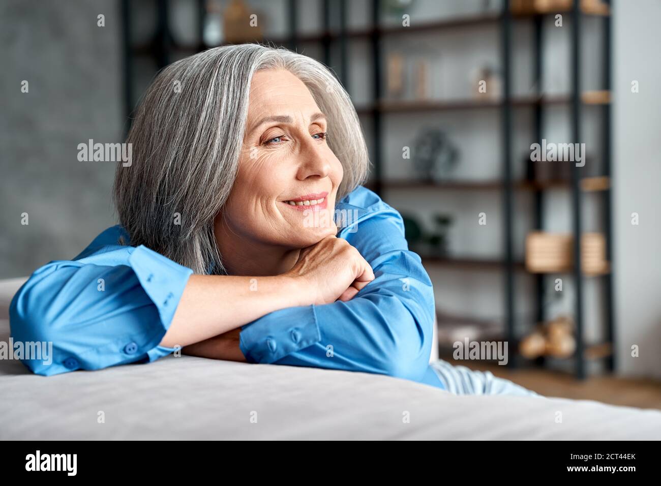 Happy relaxed mature old woman resting dreaming sitting on couch at ...