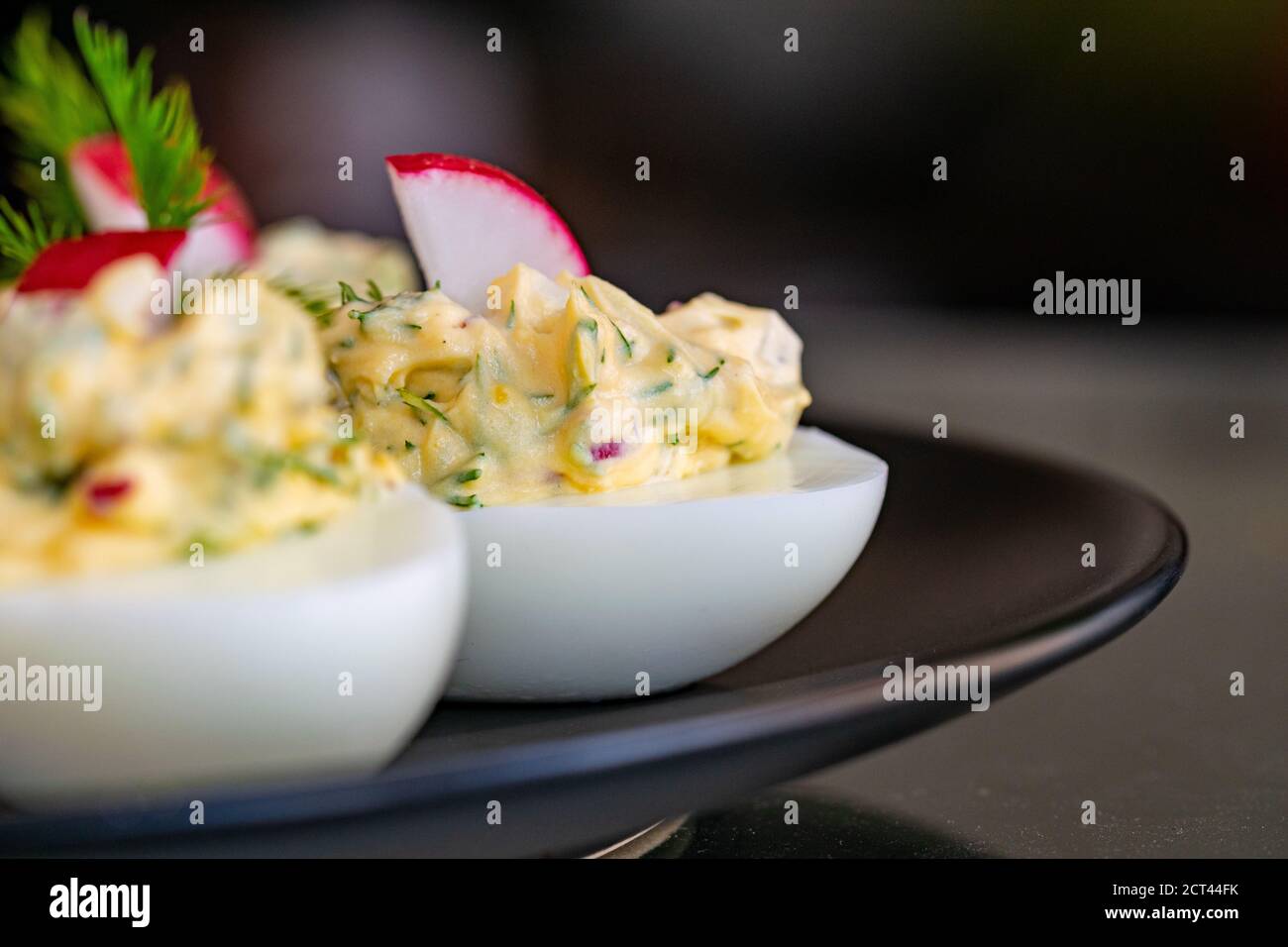 a recipe of boiled eggs filled with radish, mayonnaise, egg, onions and herbs Stock Photo Alamy