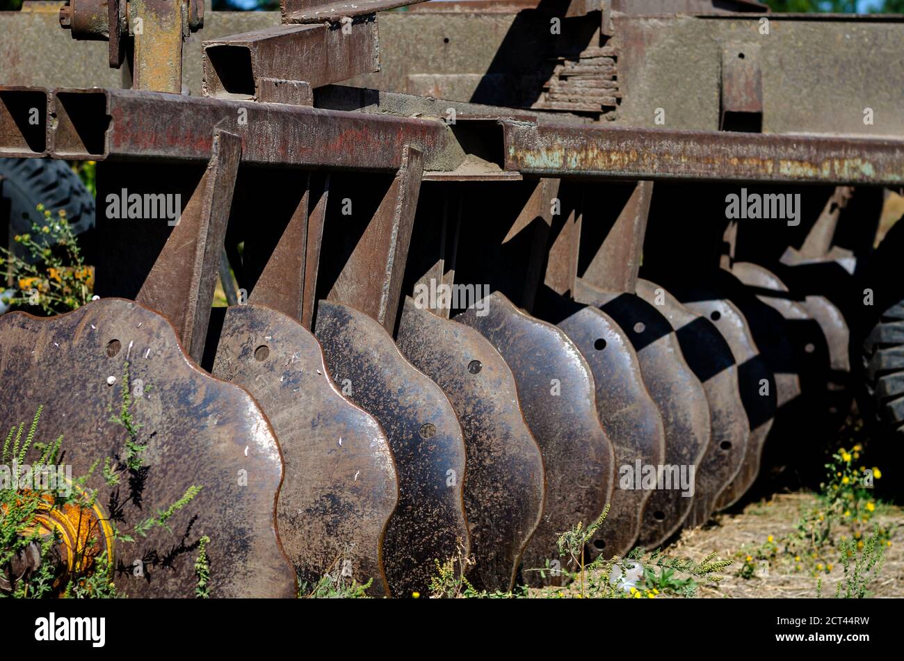 Old rusty disc harrow close up. Plow for plowing the soil. Agricultural