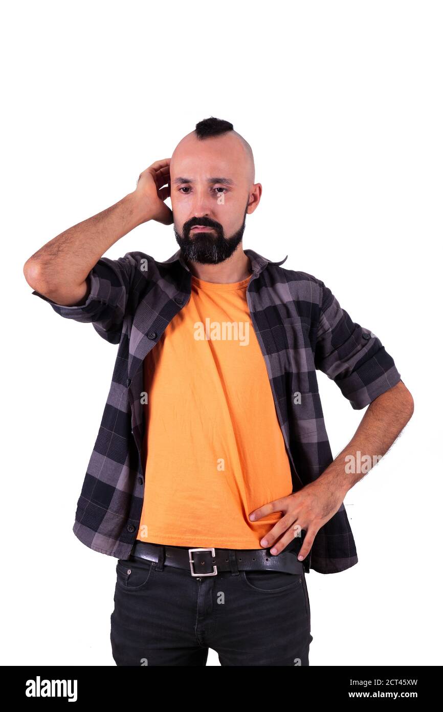 Worried young hispanic man scratching his head in confusion or worry Stock Photo