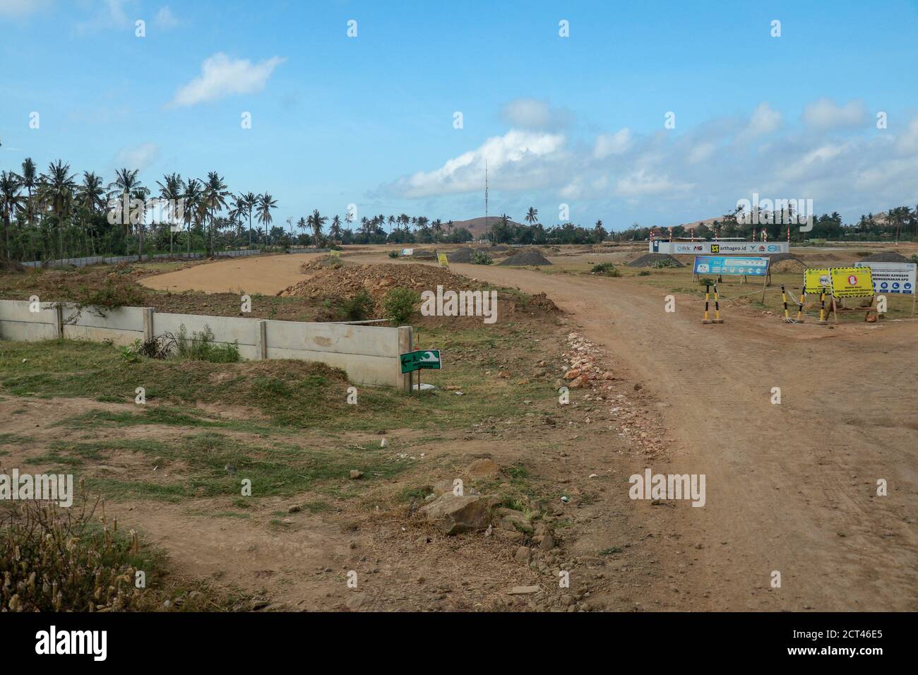 Construction of a complex on the Motogp Mandalika circuit, West Nusa Tenggara, Lombok, Indonesia. Banners with a plan of the area and the racing Stock Photo