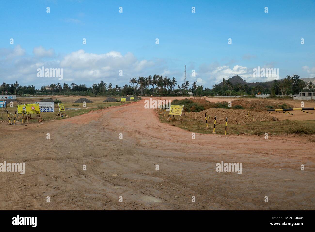 Construction of a complex on the Motogp Mandalika circuit, West Nusa Tenggara, Lombok, Indonesia. Banners with a plan of the area and the racing Stock Photo