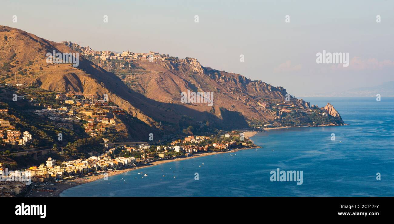 Panoramic photo of Letojanni Beach and Mazzeo Beach and the Ionian Sea (part of the Mediterranean Sea) seen from Taormina at sunset, East Coast of Sicily, Italy, Europe Stock Photo