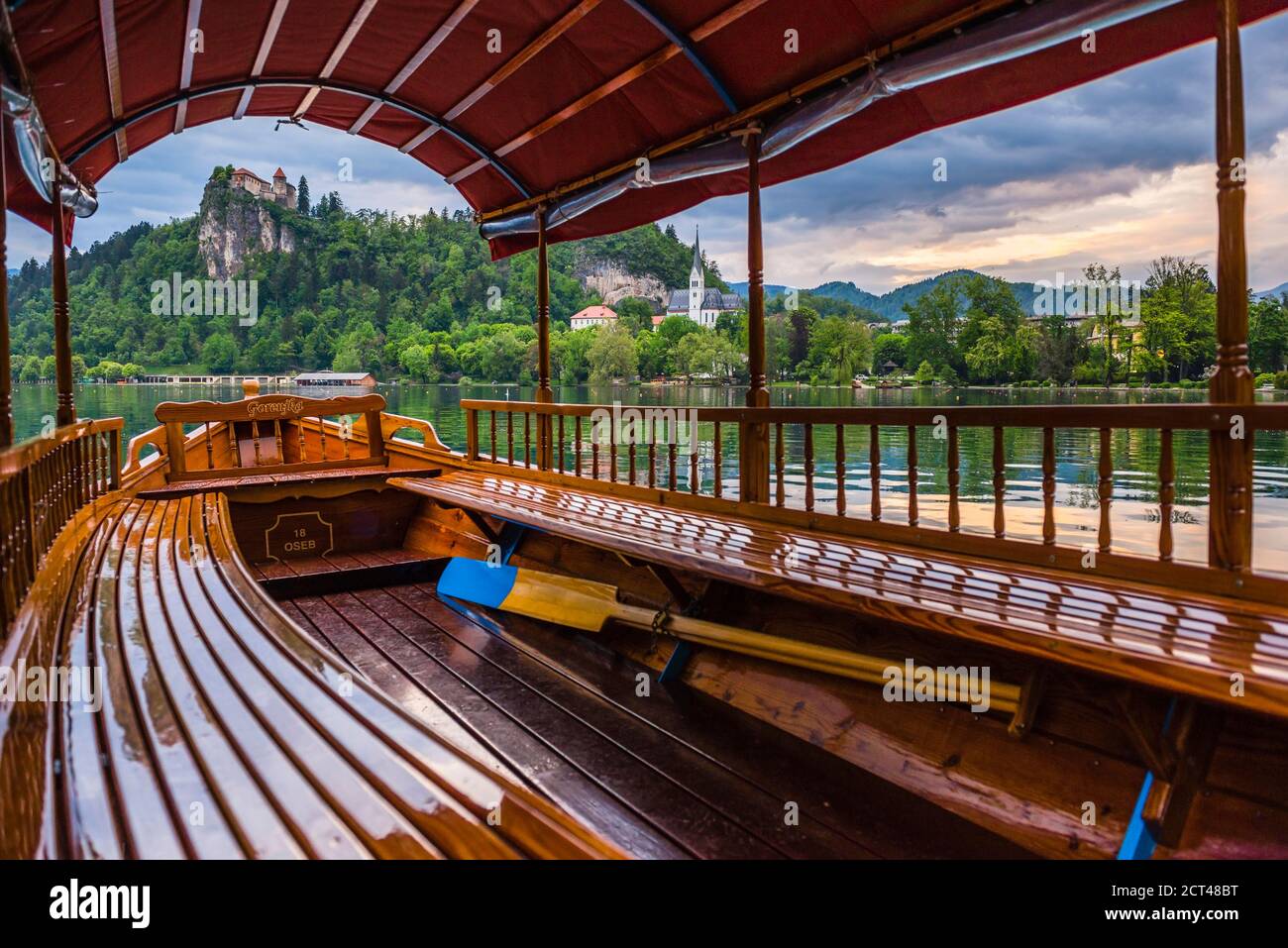 Pletna rowing boat and Lake Bled Castle, Slovenia in Bled, Julian Alps, Gorenjska, Upper