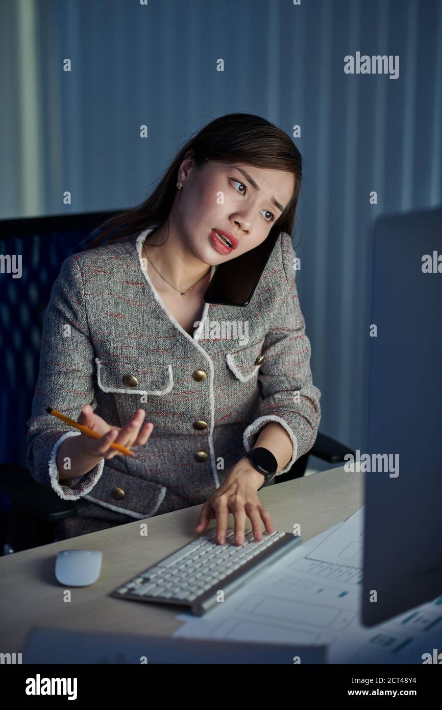 UI designer working in dark office Stock Photo
