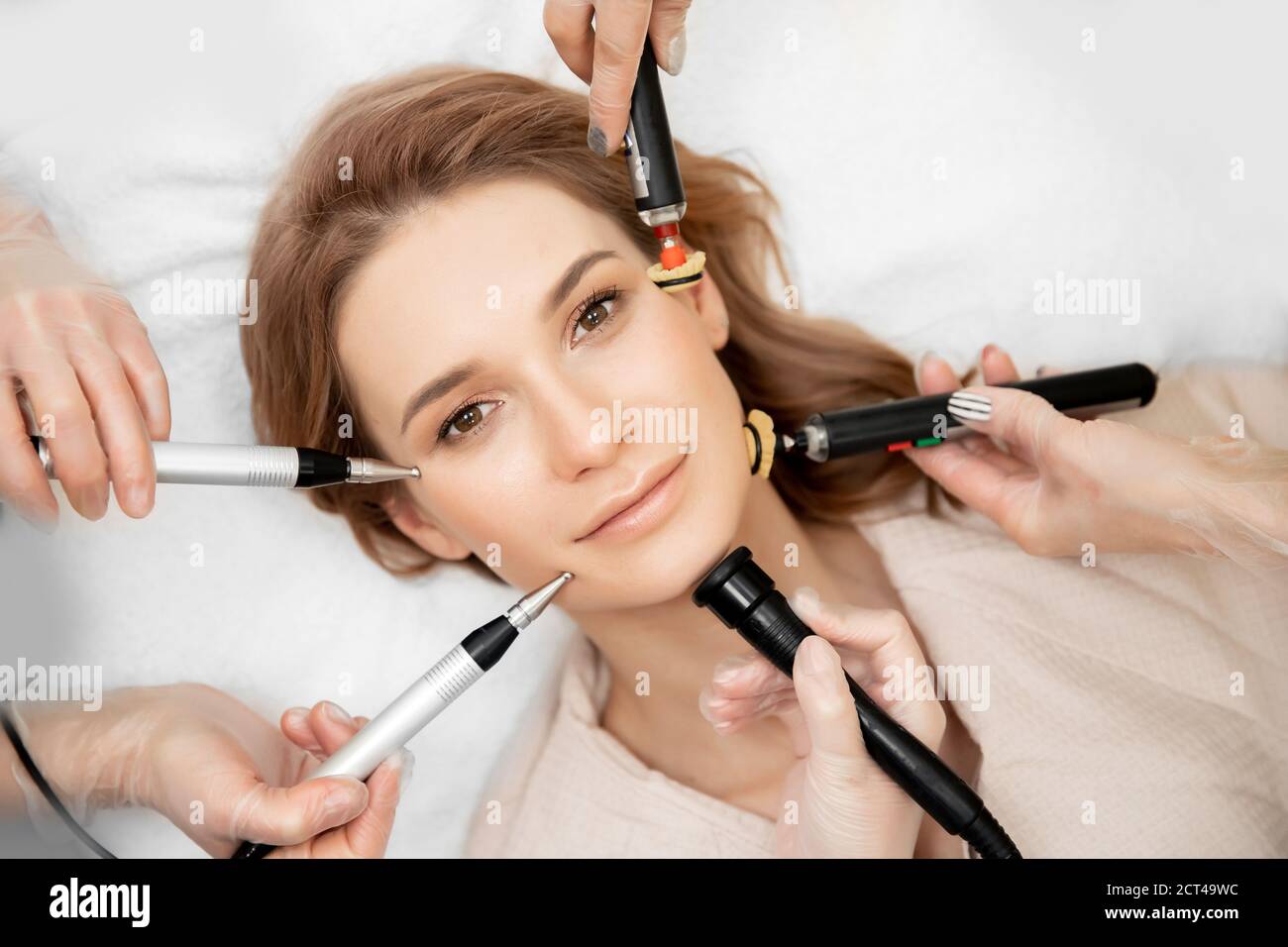 Doctor performs cosmetic spa procedure RF lifting electric facial