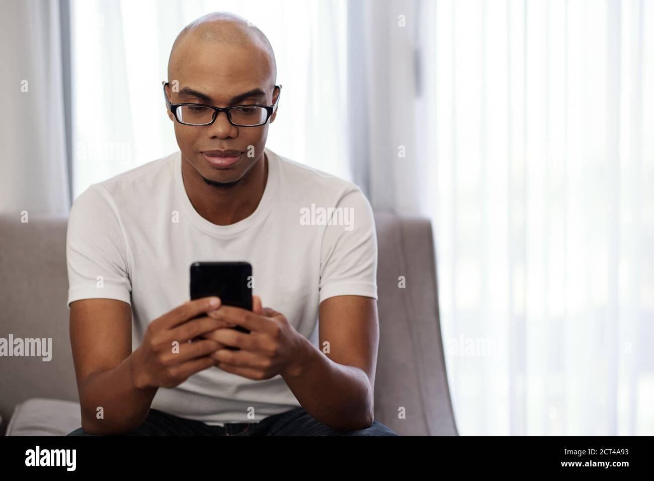 Smiling man checking smartphone Stock Photo