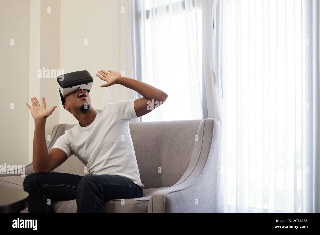 Scared man in VR headset Stock Photo