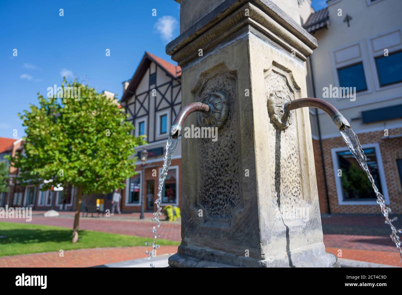 Fountain with drinking water in the center of old european town. Water resources in Europe. Focus on water flow Stock Photo