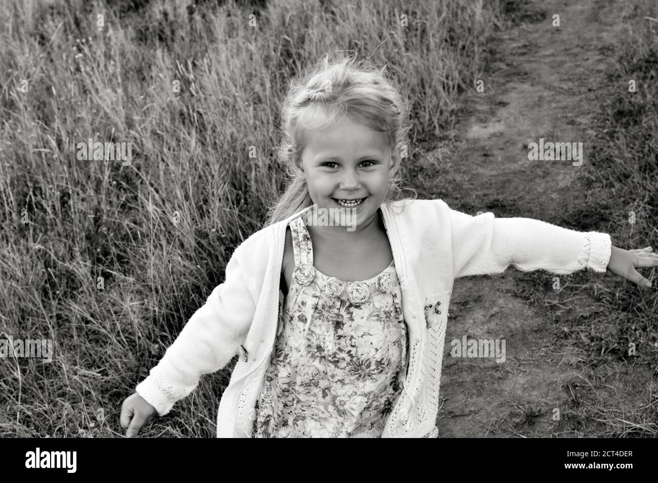 Close up black and white portrait of cute adorable smiling caucasian child. Portrait of a happy child in nature. Happy childhood concept. The baby Stock Photo