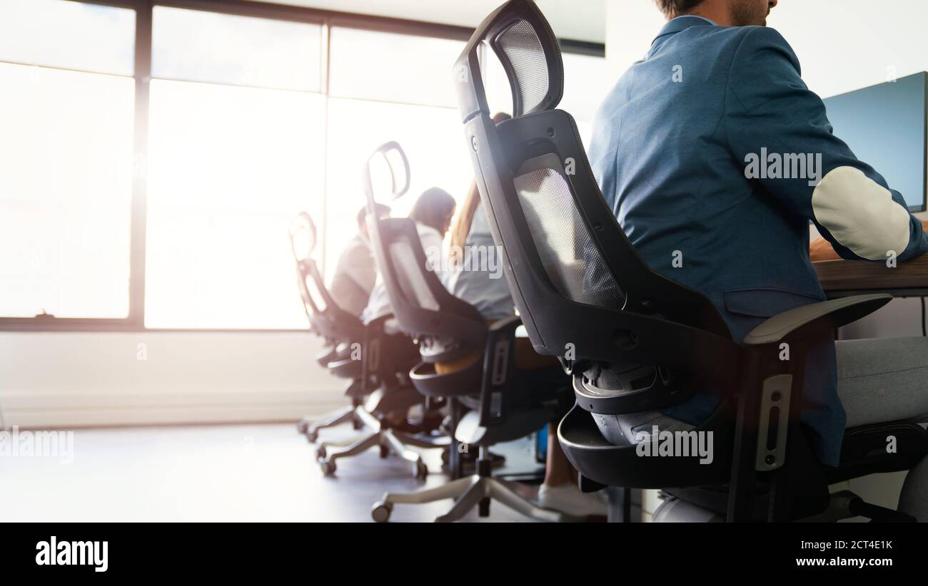 Office with programmer workers working on computers Stock Photo