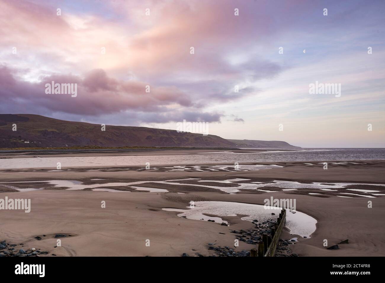 Wave breaks (groins) at sunrise, Barmouth Harbour, Gwynedd, North Wales, Wales, United Kingdom, Europe Stock Photo